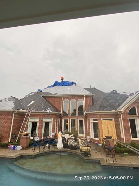 Large home roof replacement with pool in backyard